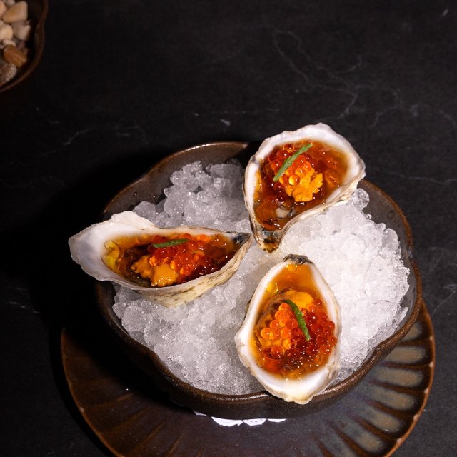 The taste trifecta: oyster topped with uni, trout roe, and …